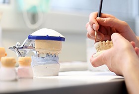 Lab technician working with smile model