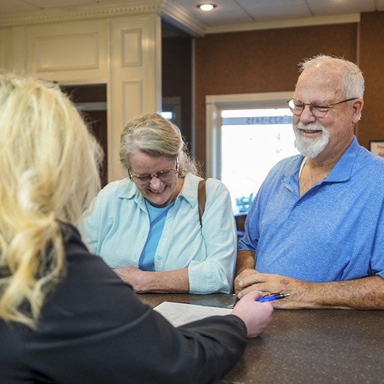 Senior couple checking in at the front desk