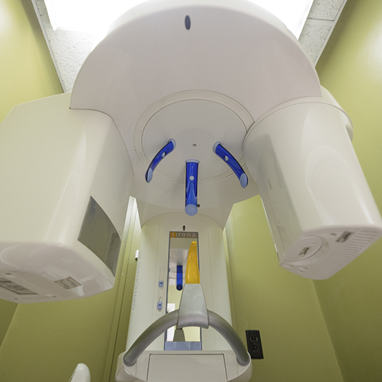 Cone beam CT scanner standing against a wall