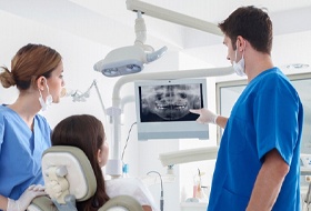 dentist showing a patient her dental x-rays