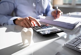 man calculating cost of cosmetic dentistry 