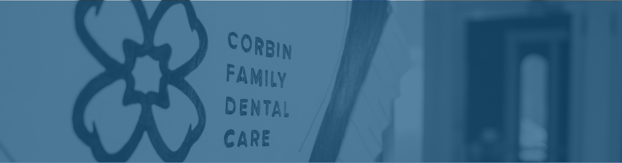 Tooth-shaped sign on the wall that reads Corbin Family Dental Care