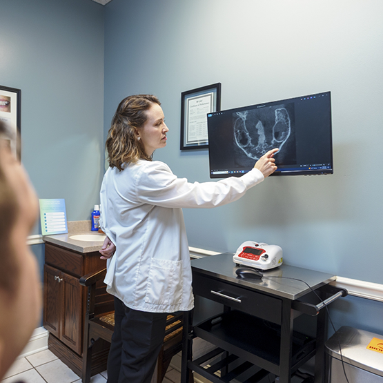 Doctor Whitaker showing a patient an x-ray of their jawbone