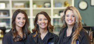 Three smiling Corbin Family Dental Care team members