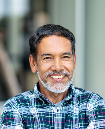 Smiling older man in a blue plaid shirt