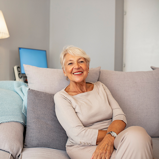 Smiling senior woman sitting on a couch