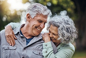 a mature couple laughing with dentures in Corbin