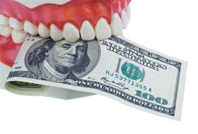 Denture biting $100 bill