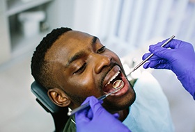 a person having their teeth examined by a dentist