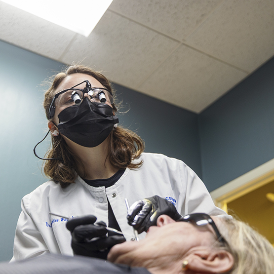 Doctor Whitaker examining a patient's mouth