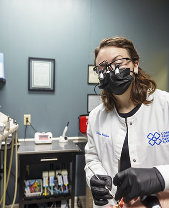 Doctor Whitaker looking at a patient's teeth
