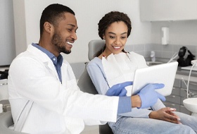 Patient learning about the money-saving benefits of dental implants