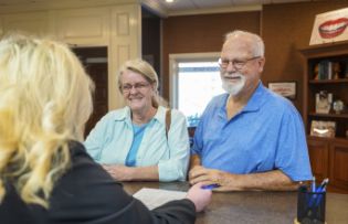 Older couple checking in at the dental office