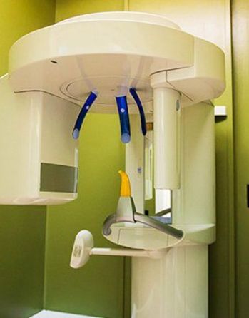 Cone beam CT scanner standing against a wall