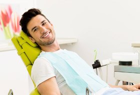 Smiling man in the dental chair.