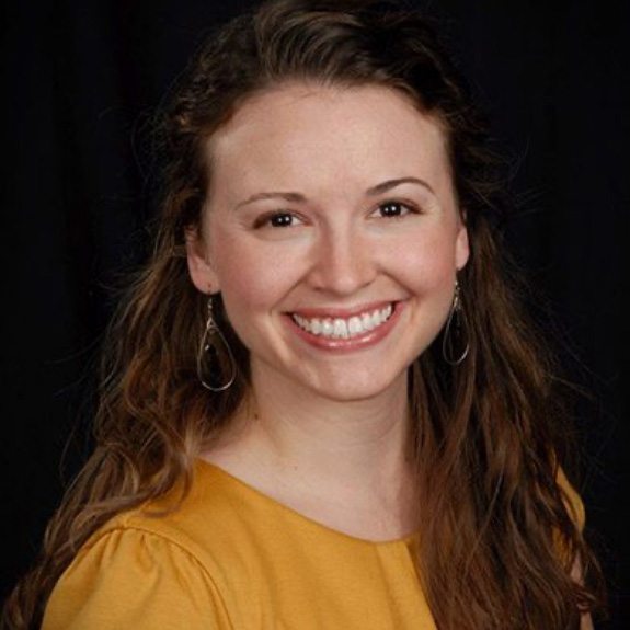 woman touching her face and smiling