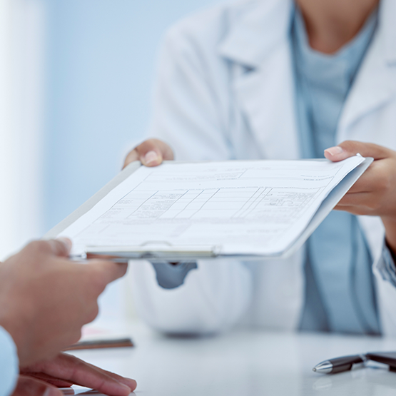 Dentist handing paperwork to a patient