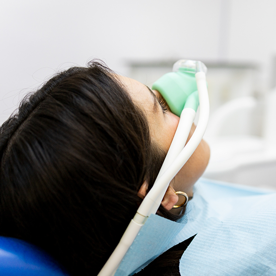 Dental patient with a nitrous oxide mask over her nose