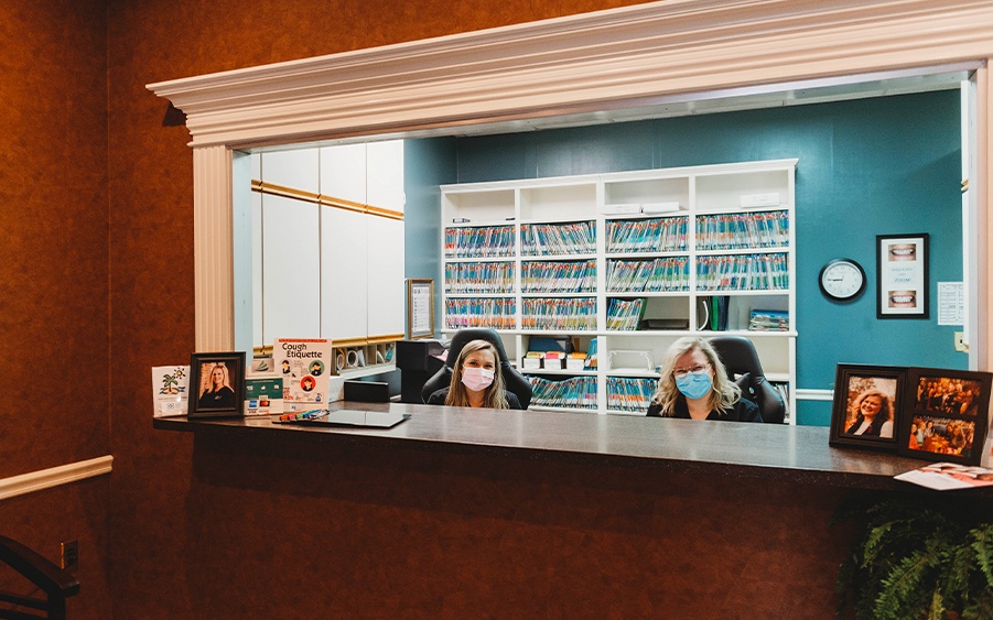 Two team members behind reception desk