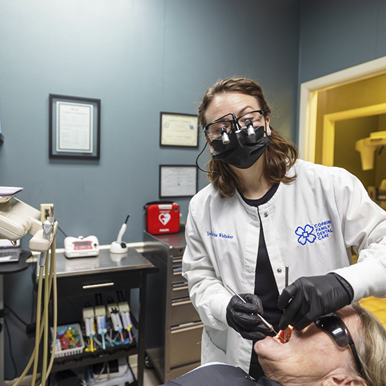 Doctor Whitaker examining a patient's teeth