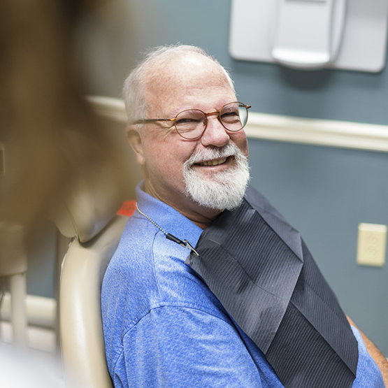 Senior man smiling at his sedation dentist near London