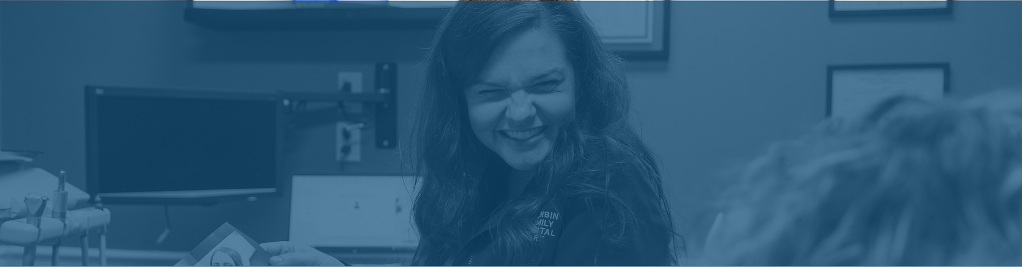 Dental team member grinning at a patient