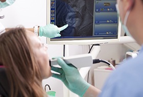 Dentist and patient looking at intraoral photos