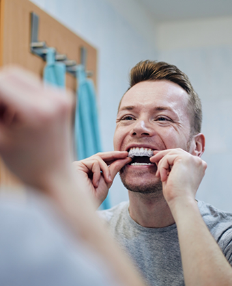 Man using a take home teeth whitening tray