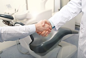Close-up of patient and dentist shaking hands