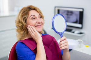 Woman admiring her new dental implants