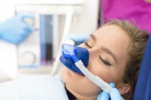 a young woman wearing a nasal mask and receiving nitrous oxide during an appointment