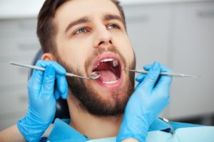 patient getting a cleaning with a dental hygienist