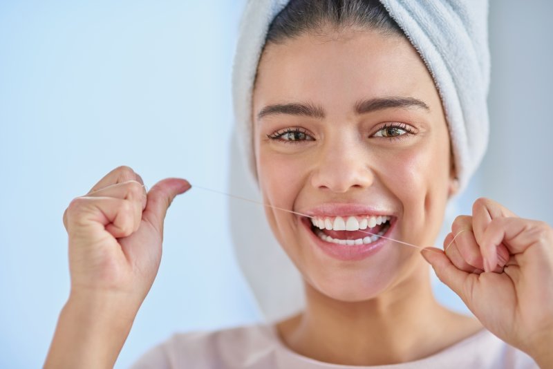 A woman flossing 