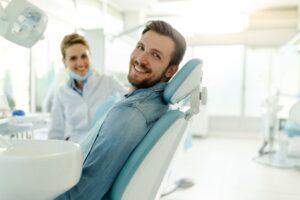 Happy dental patient looking over his shoulder