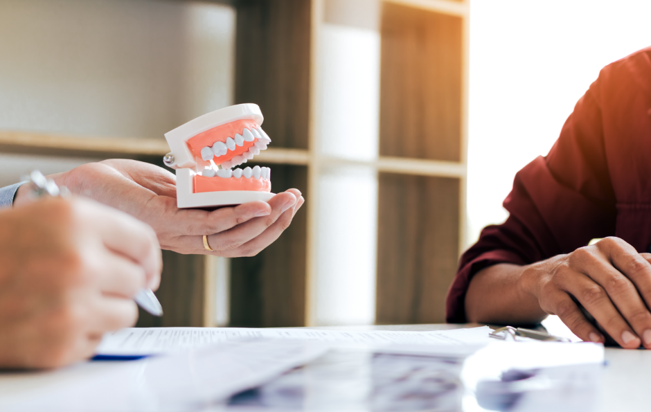 Dentist holding a pair of dentures