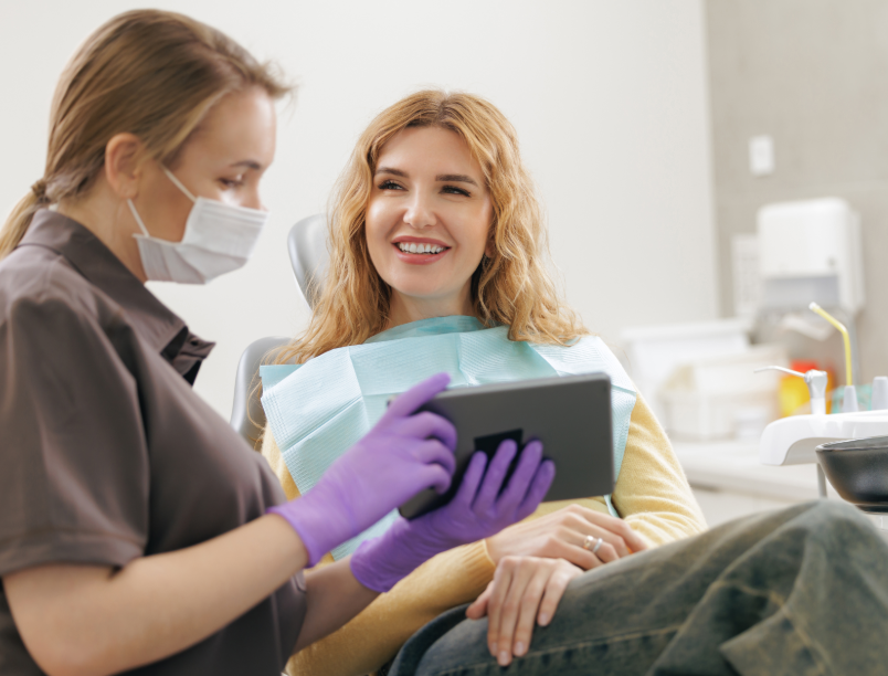 Patient and dentist looking at tablet